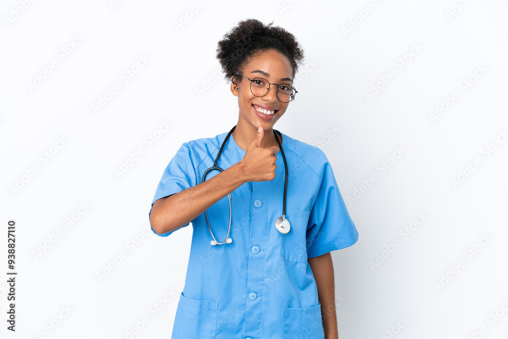 Young surgeon African American doctor woman isolated on white background giving a thumbs up gesture Young surgeon African American doctor woman isolated on white background giving a thumbs up gesture