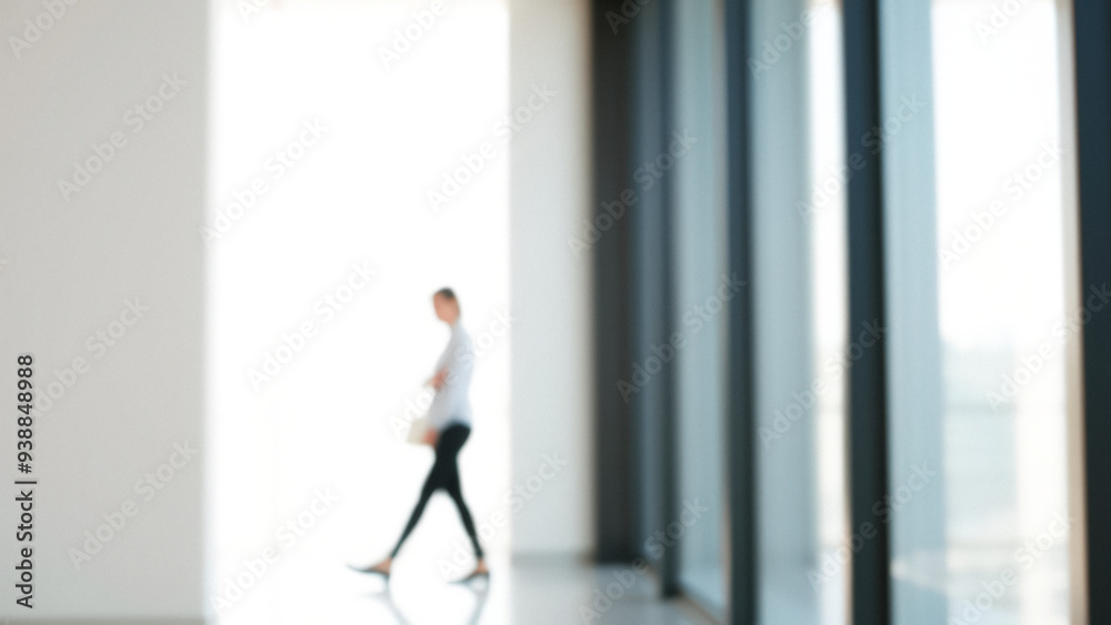 Blurred Businessperson Walking Through Modern Office Building Blurred Businessperson Walking Through Modern Office Building