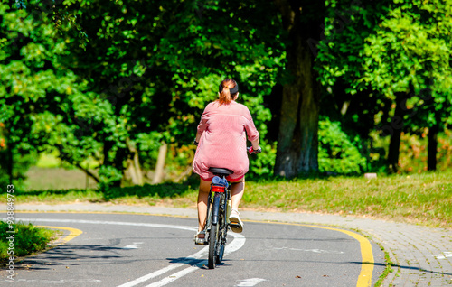 Wallpaper Mural Cyclist ride on the bike path in the city Park
 Torontodigital.ca
