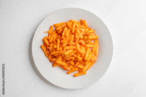 A white plate filled with raw, julienned carrots ideal for healthy meal preparation and vegan diet illustrations