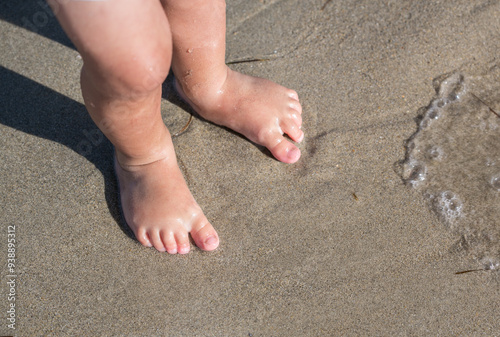 Very cute: Bare feet of a toddler in the sand on a beach