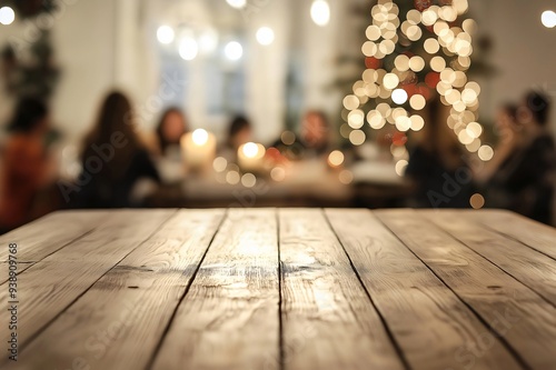 Festive wooden table with a christmas dinner party in the background