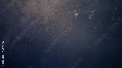 Dark and textured abstract background with a deep blue hue, creating a moody and atmospheric effect.


