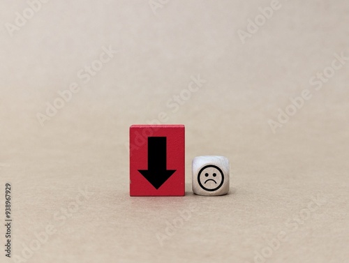Valokuva wooden doll, cube with down arrow and emotion