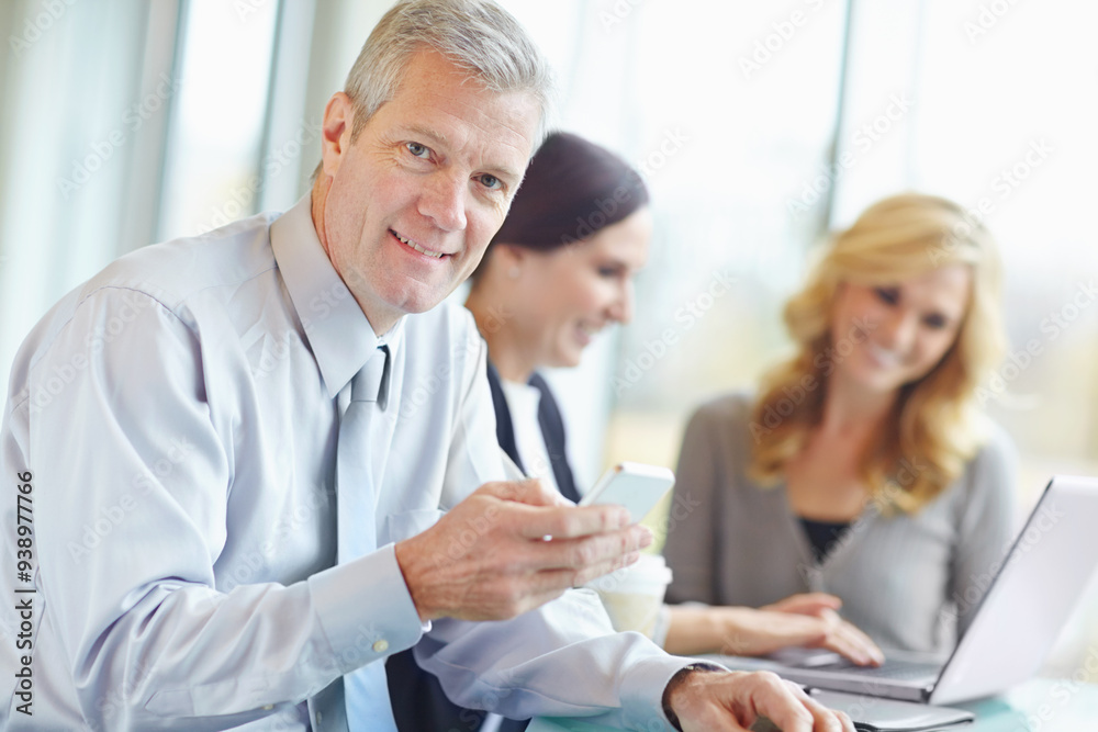 Portrait, phone and mature business man on app for email, feedback or scroll on website. Mobile, face or happy sales manager online for budget report, planning or research with team in office meeting Portrait, phone and mature business man on app for email, feedback or scroll on website. Mobile, face or happy sales manager online for budget report, planning or research with team in office meeting