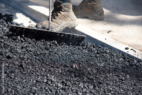 Workers Laying Fresh Asphalt on  Construction Site During Daylight Hours photo