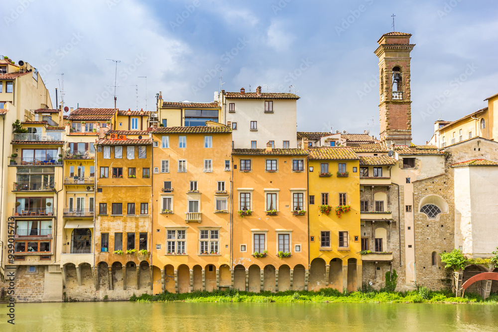 Colorful historic houses and church tower at the river Arno in Florence, Italy