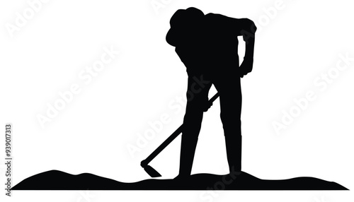 Silhouette of farmer hoeing the soil