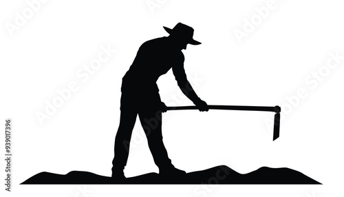 Silhouette of farmer hoeing the soil