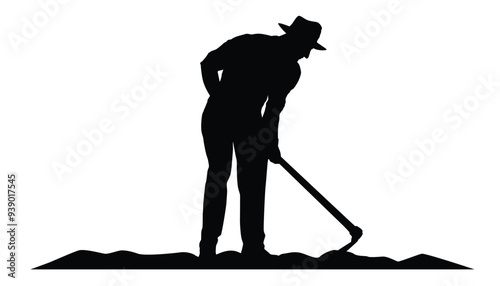 Silhouette of farmer hoeing the soil