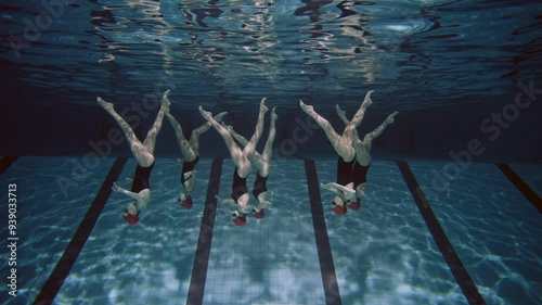 Women practicing synchronized swimming in the pool