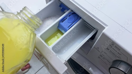 Close-up of a girl pouring powder into a washing machine. High quality FullHD footage