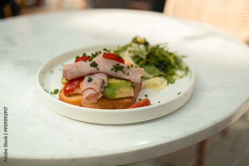 Morning eco breakfast toast with bacon, avocado and egg on a plate at city cafe. Healthy food. High quality Morning eco breakfast toast with bacon, avocado and egg on a plate at city cafe. Healthy food. High quality