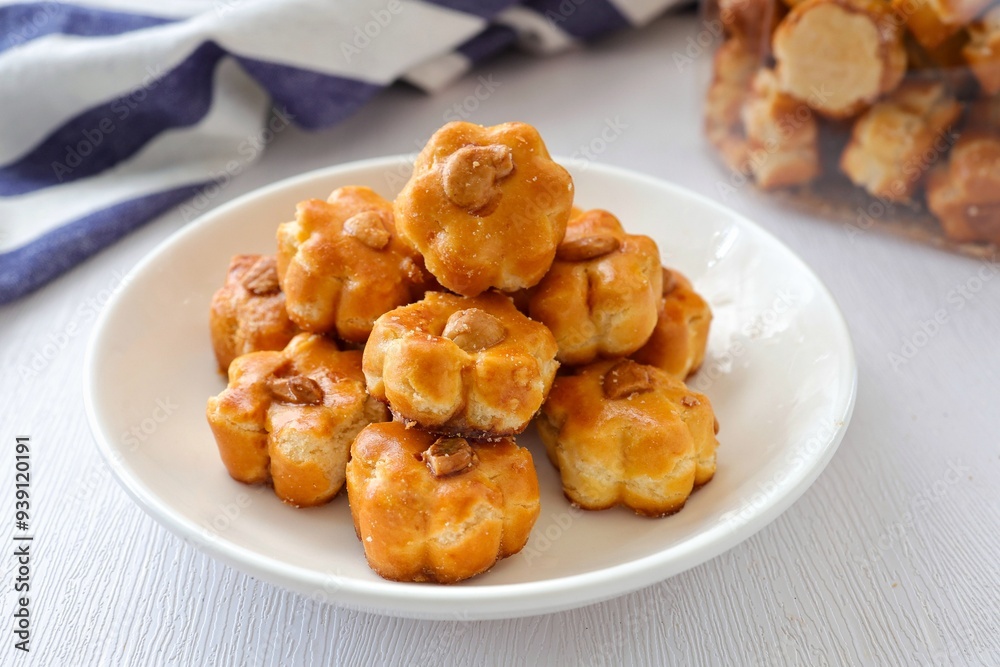 Cashew nut cookies,Singapore Cookies in a white plate on white background Cashew nut cookies,Singapore Cookies in a white plate on white background