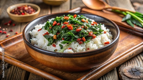 Freshly cooked white rice mixed with wilted spinach and garnished with a sprinkle of paprika, served in a simple yet elegant ceramic bowl. photo