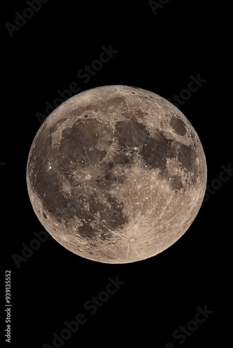 An original vertical photograph of the super blue moon with dark night background - full moon as seen through a telescope