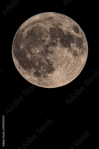 An original vertical photograph of the super blue moon with dark night background - full moon as seen through a telescope - space for caption
