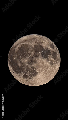 An original vertical photograph of the super blue moon with dark night background - full moon as seen through a telescope