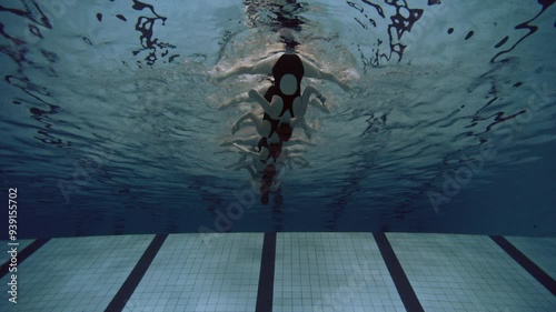 Underwater shot of six women practicing synchronized swimming lined up