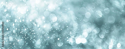 Abstract blue bokeh background with white and silver circles and glitters.