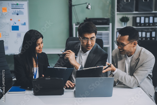 Group of colleagues engaging in a discussion during a business meeting in a conference room. Happy business people, men and women, collaborating and working towards their shared goals.