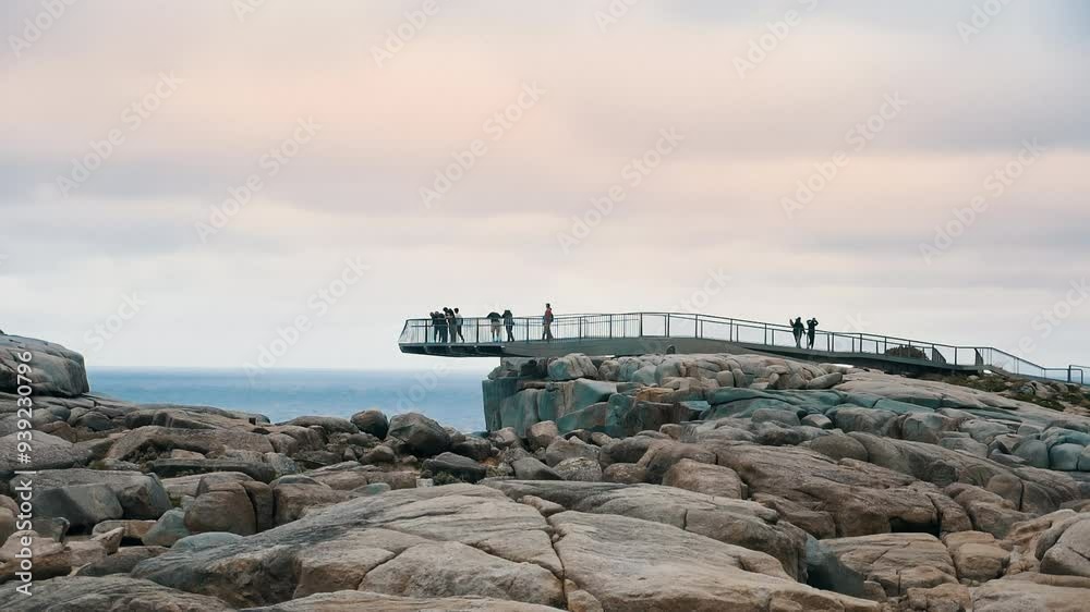 shot from beneath a cliff side viewing platforn, people walks to the edge to look down. shot from beneath a cliff side viewing platforn, people walks to the edge to look down.