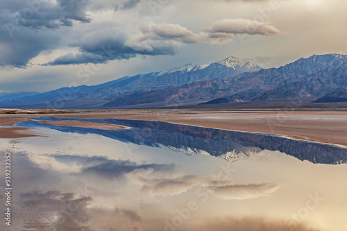 Landscape of Cottonball Basin and the Panamint Mountains with reflections in calm water, Death Valley National Park, California, USA photo