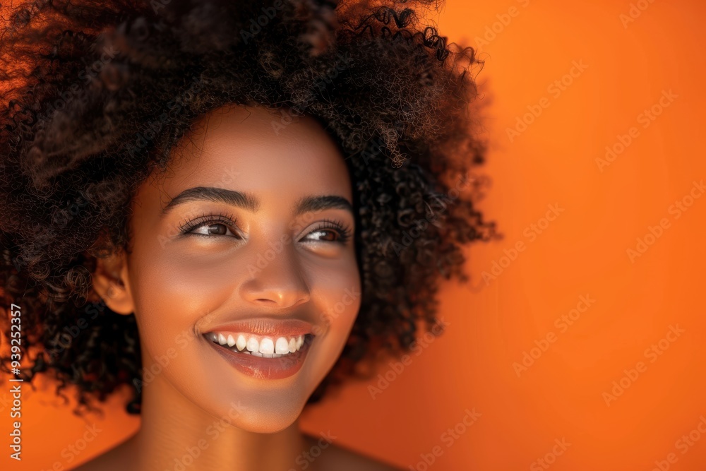 Smiling model showcasing natural beauty and skincare on a vibrant backdrop, featuring healthy skin and organic hair treatment