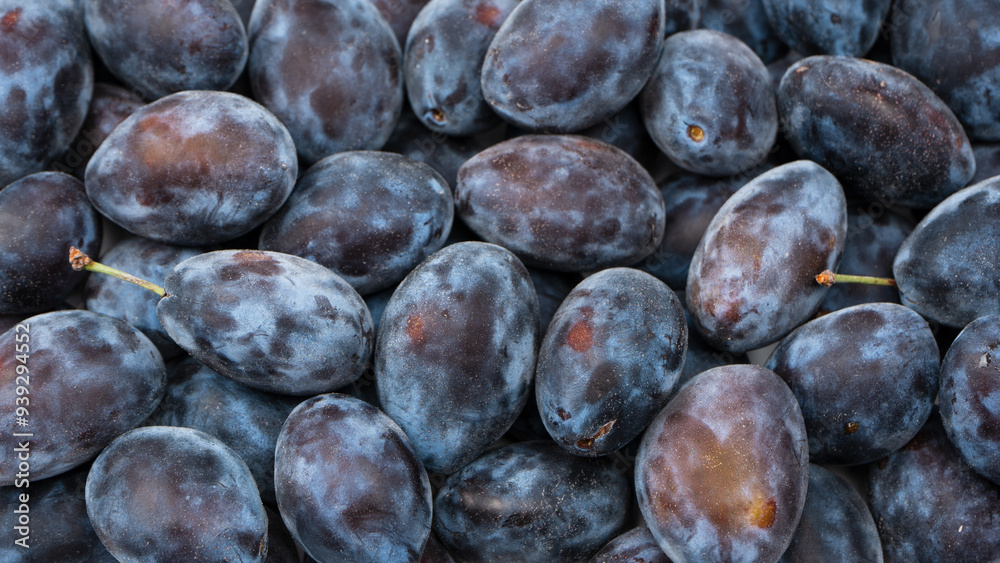 Fototapeta premium Fresh plums background. Top view. Organic food.