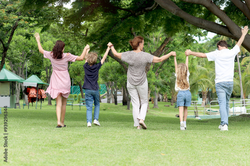 Happy cheerful family hold hands and raise up, walk in line together outside. Father, mother, daughter girl, son boy and elderly grandma in summer garden. Joyful kid, parents and senior at green park. Happy cheerful family hold hands and raise up, walk in line together outside. Father, mother, daughter girl, son boy and elderly grandma in summer garden. Joyful kid, parents and senior at green park.