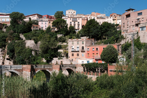 View of bridge over Francoli river and La Riba town on sunny summer day. Tarragona Province, Spain. photo