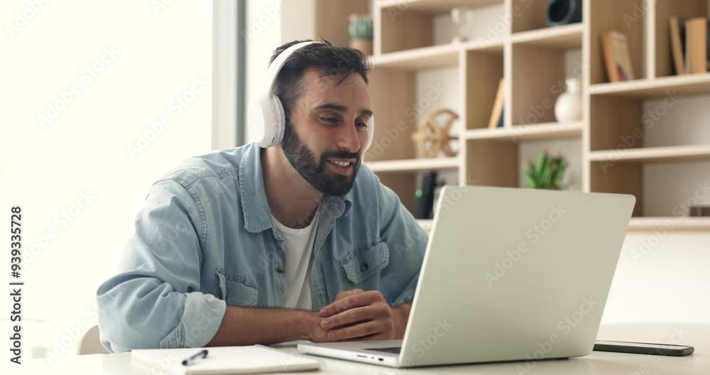 Happy Hispanic business man in big headphones talking on video call, using laptop for freelance job communication, waving hand hello at display, smiling, speaking on online conference chat Happy Hispanic business man in big headphones talking on video call, using laptop for freelance job communication, waving hand hello at display, smiling, speaking on online conference chat
