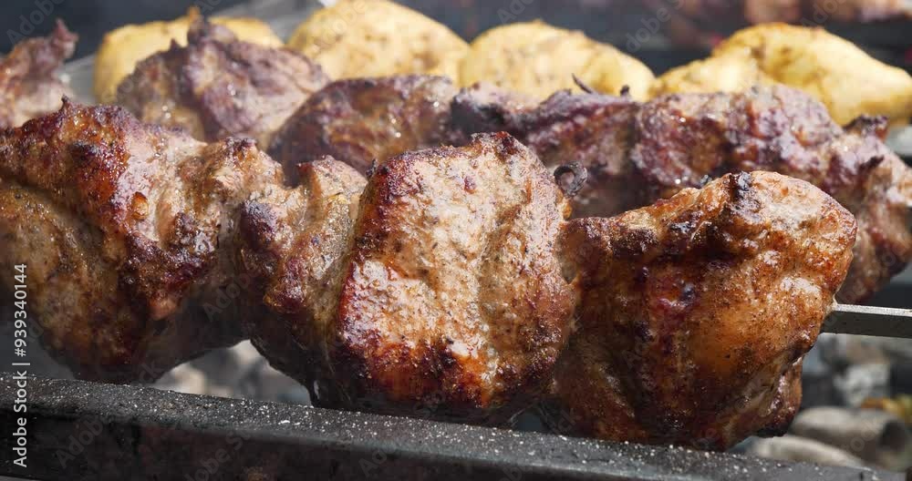 Shish kebabs with different meats rotates on spits Shish kebabs with different meats rotates on spits