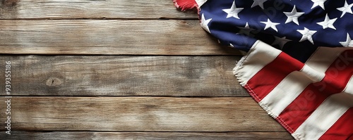 American flag draped on rustic wood background with copy space.