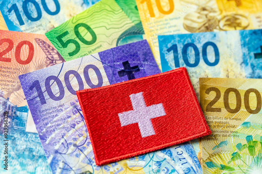 Swiss francs and flag of alpine country, all denominations, concept, economics and finance, money of Switzerland, close up