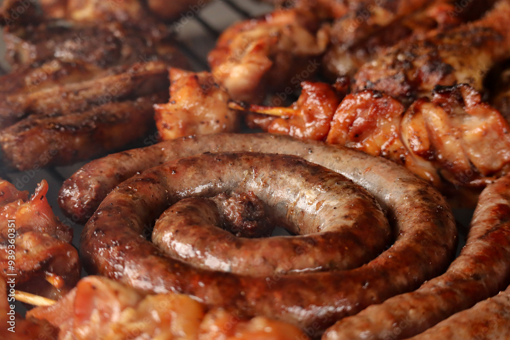 grilled sausage on the grill. South African braai meat including Boerewors, kebabs and chops grilled sausage on the grill. South African braai meat including Boerewors, kebabs and chops