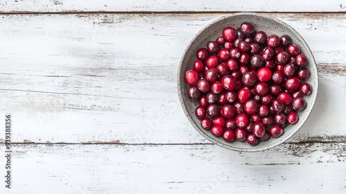 Dried cranberries in gray bowl, overhead. photo