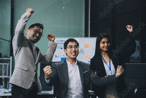 Group of colleagues engaging in a discussion during a business meeting in a conference room. Happy business people, men and women, collaborating and working towards their shared goals.