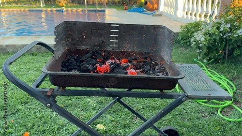 Slow Motion of Charcoal Igniting in a Backyard Barbecue Grill