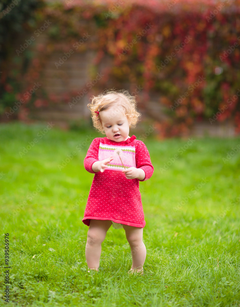 Child in fall park. Kid with autumn leaves.