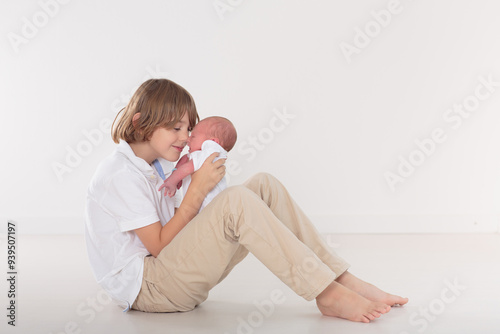 Siblings meet newborn baby photo