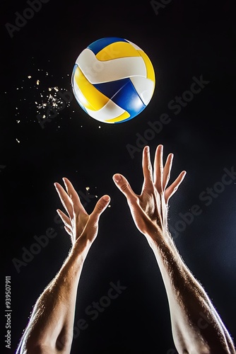 A volleyball player reaches up to spike a volleyball, the ball is in mid air against a black background.