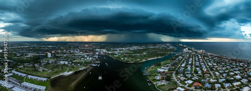 Aerial Panoramic view of Heavy clouds of a storm front over the Loxahatchee River and the city of Jupiter in early August. Rain is visible, which pours out of the clouds on the city