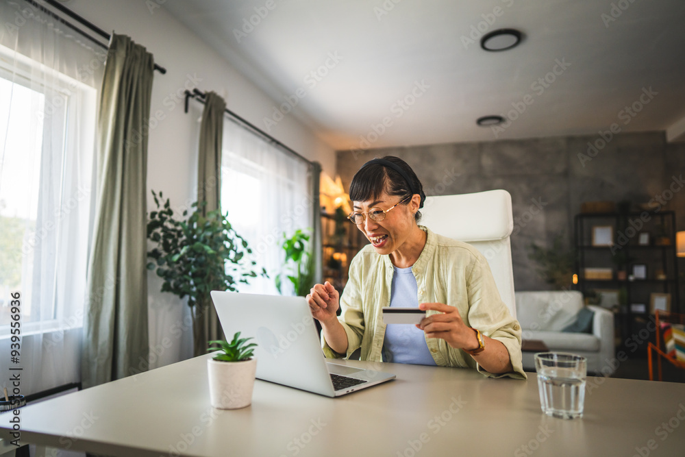 © Miljan Živković - mature happy japanese woman buy online on laptop with credit card © Miljan Živković - mature happy japanese woman buy online on laptop with credit card