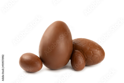 Easter chocolate egg isolated on white background. Easter celebration concept. Happy Easter. Chocolate sweet eggs. Candies on textured wooden table. Space for text.Copy space