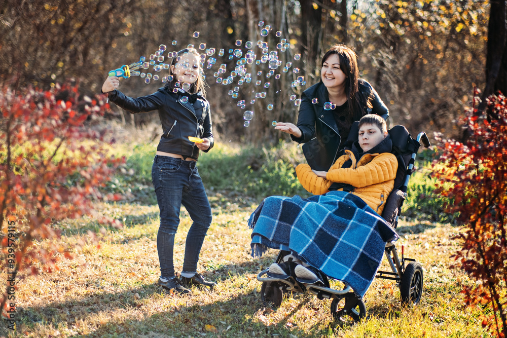 Mother and sibling spending quality time with child in wheelchair, outdoor play with bubbles, special needs bonding, family support, disability inclusion. Mother and sibling spending quality time with child in wheelchair, outdoor play with bubbles, special needs bonding, family support, disability inclusion.