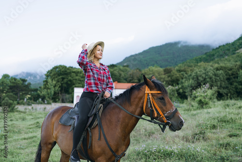 A woman is riding a horse in a field