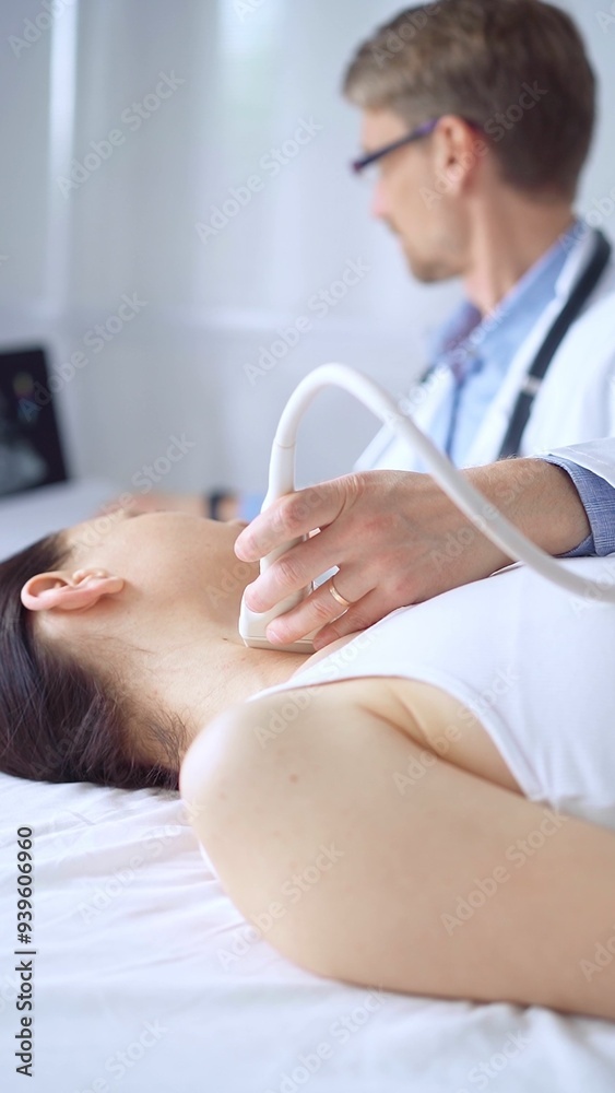 Doctor man using ultrasound equipment on the neck of a patient woman, lying for examination. Medicine concept Doctor man using ultrasound equipment on the neck of a patient woman, lying for examination. Medicine concept