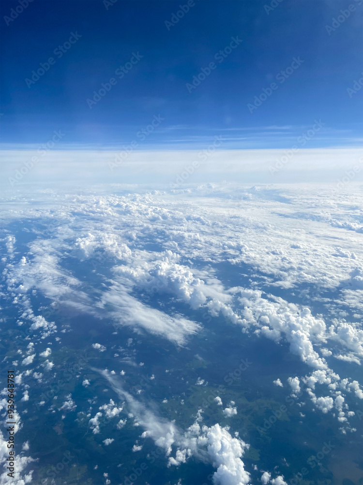 Fototapeta premium above view of clouds over earth and dark blue sky