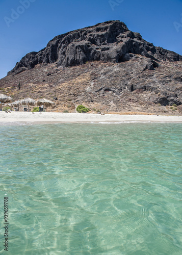 Sunny summer vacation morning in EL TECOLOTE BEACH, with mountains and the crystal clear water of the Sea of Cortes, infront of the ESPIRITU SANTO Island. Seascape of La Paz BCS Mexico. Vertical view photo